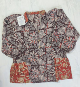 Floral patterned shorts with a tag on a white surface