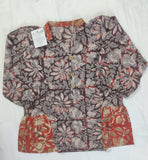 Floral patterned shorts with a tag on a white surface